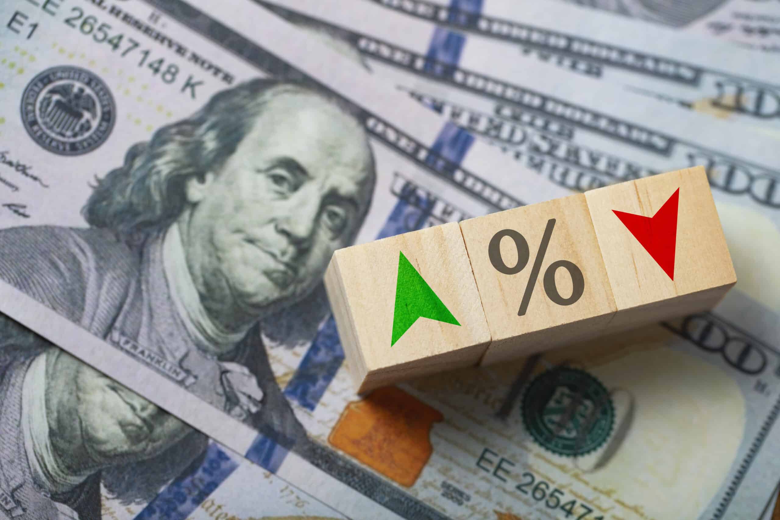 The central banking system of the United States and changing interest rates. Percentage symbol and arrow symbol on the wooden cube.