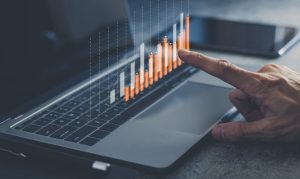 Laptop or computer with chart. Investment in business and financial concept of growth and success. Investor data analysis for planning in strategy of stock market fund. Invest for earning or profit.