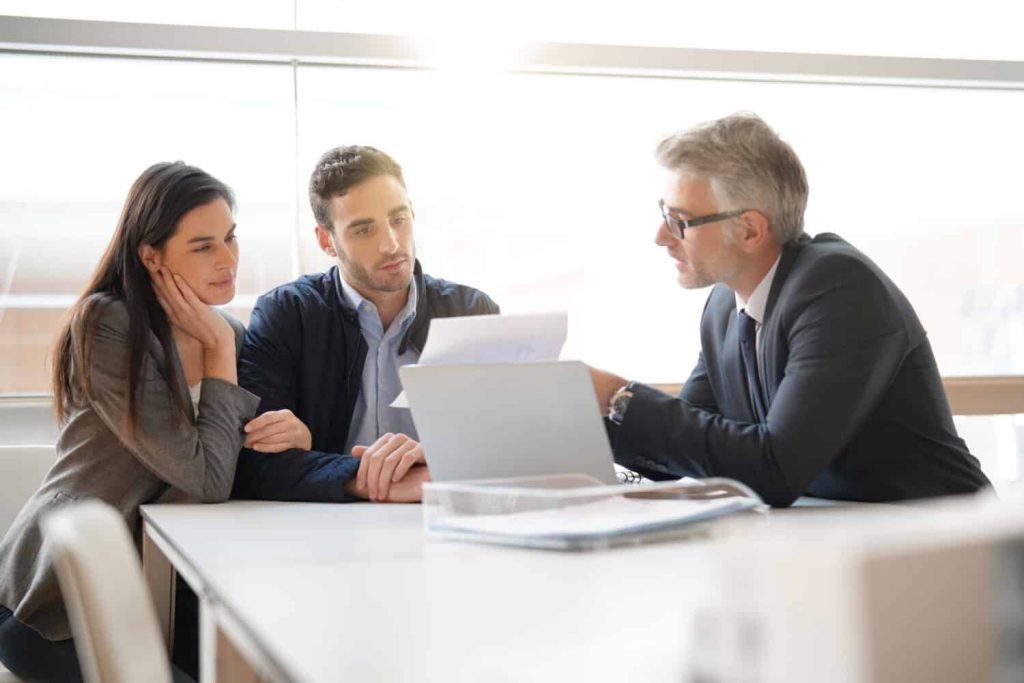 Young couple meeting financial advisor for home investment
