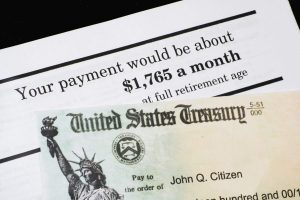 A Corner of Social Security Administration annual statement showing benefits amount at full retirement age with SSA check. Concept of retirement planning.