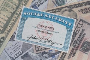 Fake Social security card on prop US currency .