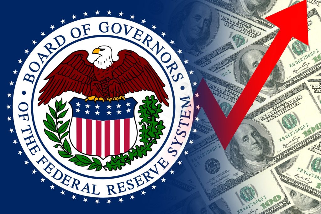 The official seal of the Board of Governors of the Federal Reserve System, colored red, white, blue, and gold, is displayed on a dark blue background. The seal partially overlays a bright background composed of scattered U.S. one hundred-dollar bills. A large, diagonal red arrow points from the lower left corner towards the upper right corner across the image.