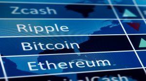 A close-up of a digital screen displaying cryptocurrency names like Zcash, Ripple, Bitcoin, and Ethereum, against a blue background with a faint world map. Green and red triangular arrows indicating market trends are visible on the right side of the screen, suggesting price movements.