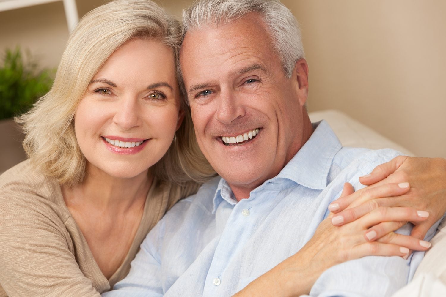 Happy senior man and woman couple together at home smiling, healthy and happy