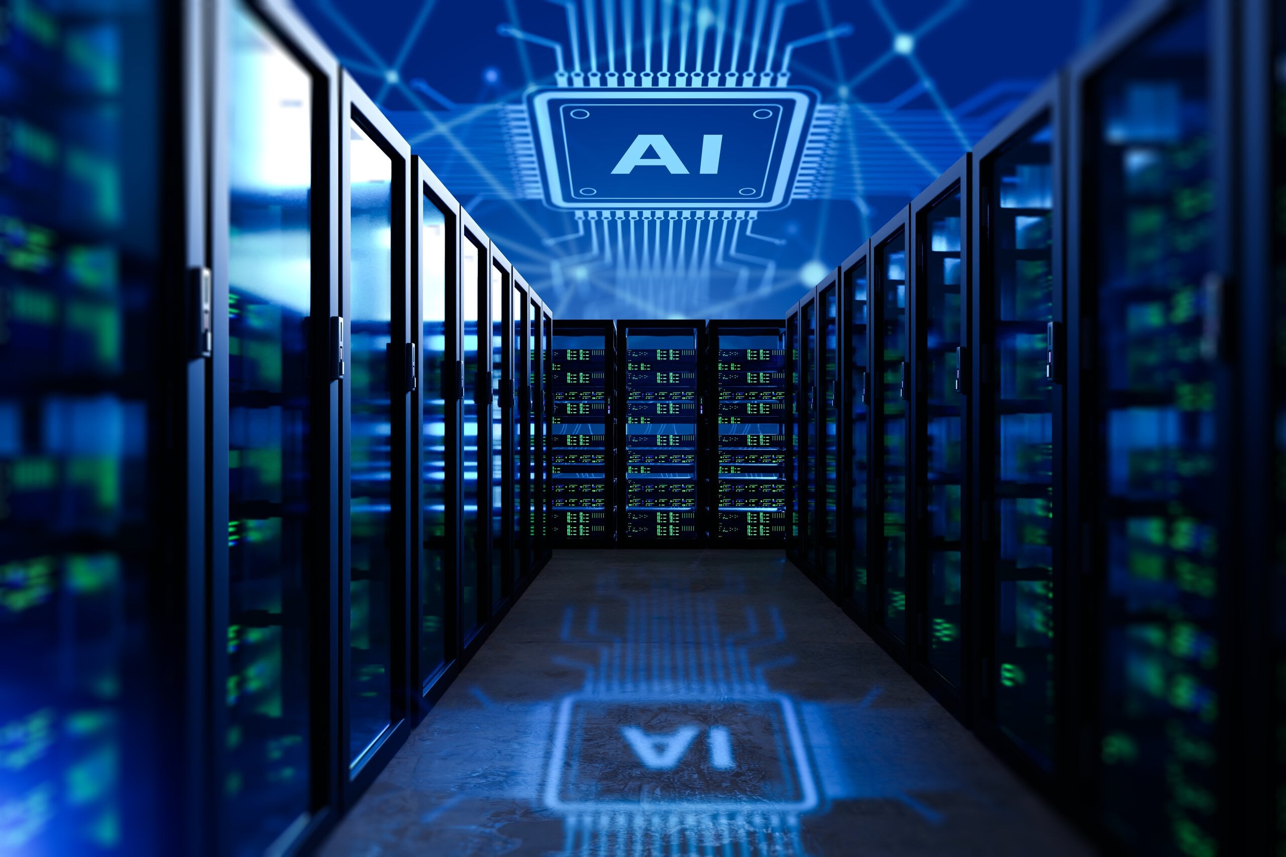 A long, dark data center corridor is illuminated by blue and green lights emanating from server racks lining both sides. A large, luminous blue graphic of a microchip with the letters 'AI' is projected onto the ceiling and its inverted reflection appears on the glossy floor. The background features a blurred blue network circuit pattern, reinforcing the high-tech, digital theme.