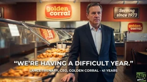 A man in a dark suit and light blue collared shirt stands in the middle of a Golden Corral buffet restaurant. He looks forward with a serious expression. Behind him are several food warming trays with various dishes, and in the background, red walls with the orange 'golden corral' logo and a black sign stating 'Serving since 1973'. White overlay text reads 'WE'RE HAVING A DIFFICULT YEAR.' and below it, 'LANCE TRENARY, CEO, GOLDEN CORRAL - 41 YEARS'. A '24/7 WALL ST.' logo is in the bottom right corner.
