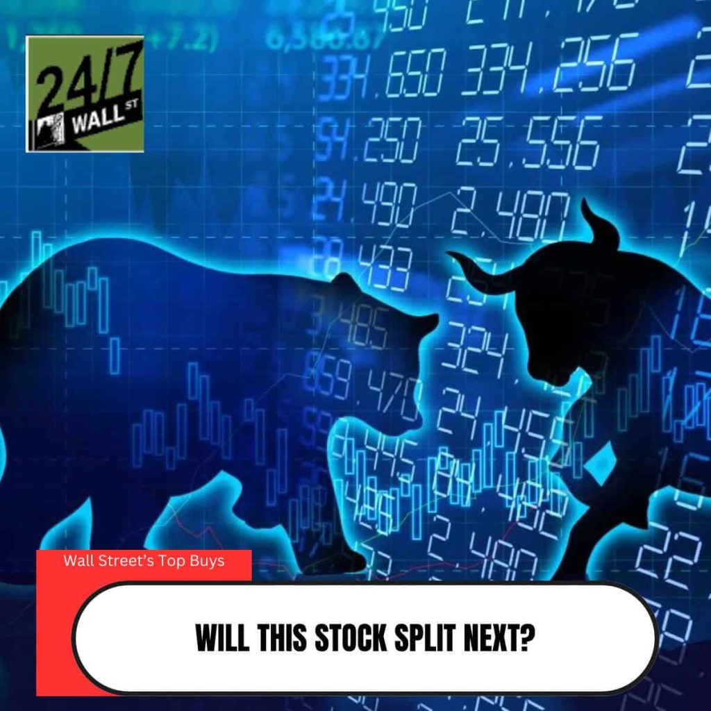 A blue-toned graphic depicting the silhouettes of a bear on the left and a bull on the right, superimposed over a glowing digital stock market background with numbers and bar charts. In the top left corner is the '24/7 WALL ST' logo. A red banner in the bottom left states 'Wall Street's Top Buys'. At the bottom center, a white oval contains the question 'WILL THIS STOCK SPLIT NEXT?' in black capital letters.