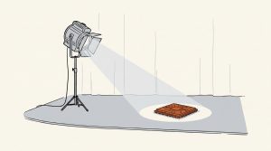 Illustration: a stage spotlight shining on an orange computer chip
