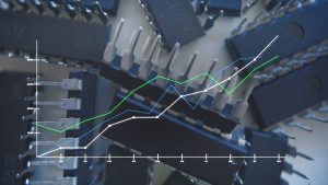 A line graph depicting increasing values over eleven months, overlaid on a background of scattered black integrated circuit (IC) chips. The graph has a y-axis scaled from 0 to 300,000, and an x-axis labeled with months from January to November. Three lines, one white solid, one green solid, and one blue dotted, all show an upward trend, indicating growth. The chips are dark grey to black with silver pins, some showing numbers like '6612' and '28'.